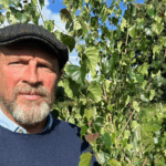 Photo of James Reed CBE next to a tree