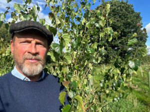 Photo of James Reed CBE next to a tree